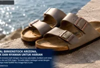 Sepasang sandal Birkenstock Arizona dengan desain dua strap ikonik dan footbed ergonomis.