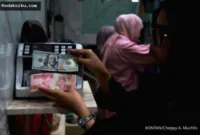 Proyeksi Rupiah — Grafik pergerakan nilai tukar rupiah yang menunjukkan tren penguatan di tengah sentimen global.